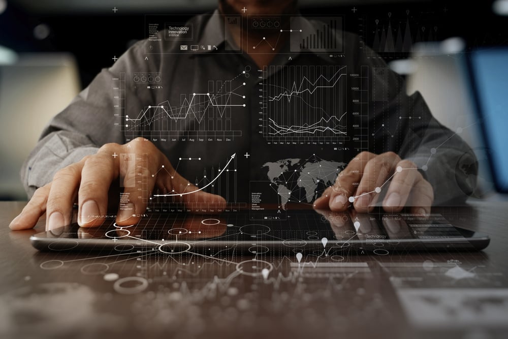 businessman hand working on laptop computer with digital layer business strategy and social media diagram on wooden desk