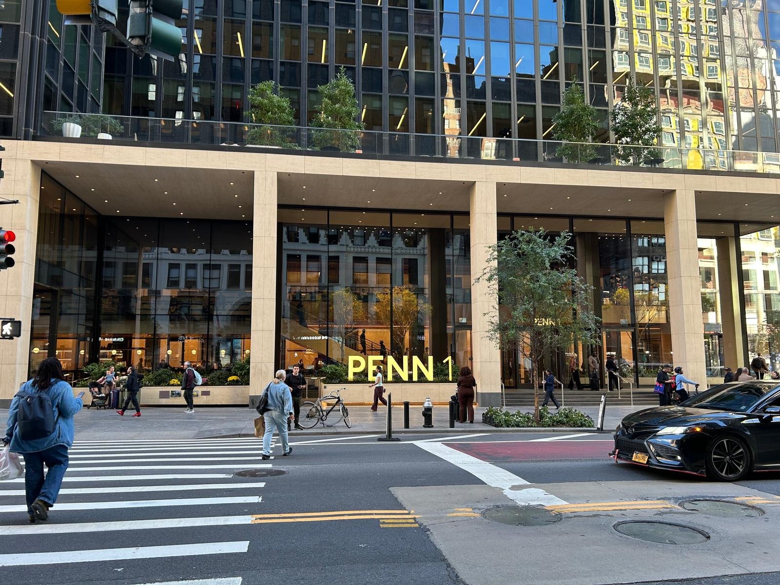Photo of the front entrance of Penn 1 in New York City with a yellow